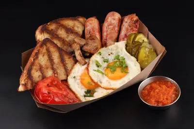 Scrambled eggs with mushrooms, Dijon sausages and baked tomatoes Myastoriya Meat Bar Ivano-Frankivsk undefined photo